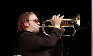 Member of the Fun Loving Criminals on stage playing the trumpet at T in the Park July Member of the Fun Loving Criminals on stage playing the trumpet at T in the Park July
