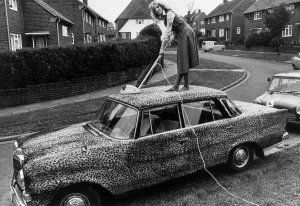 Mercedes car covered in leopard skin being hoovered 1989 Housework cleaning car Mercedes car covered in leopard skin being hoovered 1989 Housework cleaning car