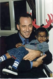 Images Dated 15th December 1993: MICHAEL BARRYMORE, COMEDIAN, HOLDING A LITTLE BOY 15 / 12 / 1993