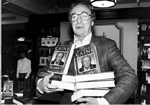 Images Dated 7th October 1992: Michael Caine Actor with copies of his autobiography Whats It All About