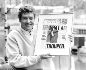 Michael Crawford holds up a framed front page of the Daily Mirror June 1987 Michael Crawford holds up a framed front page of the Daily Mirror June 1987
