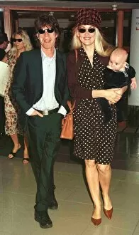 Images Dated 13th May 1998: Mick Jagger pop singer and wife Jerry with their new baby leave Heathrow for Nice