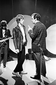 Mick Jagger talks to the TV director during rehearsals at Teddington for the Eamonn