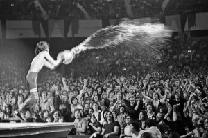 Mick Jagger throwing water over the crowd during a Rolling Stones performance at Earls Mick Jagger throwing water over the crowd during a Rolling Stones performance at Earls