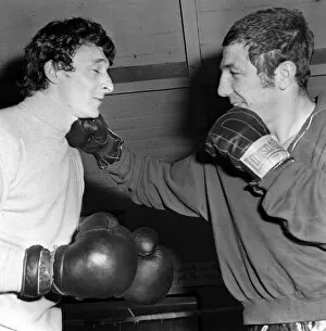 Images Dated 28th January 1971: Mike Summerbee gets a right hander from heavyweight boxer Kevin Madden in the Gym where
