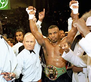 Mike Tyson has his arms raised by referee Mills Lane after beating Frank Bruno for Mike Tyson has his arms raised by referee Mills Lane after beating Frank Bruno for