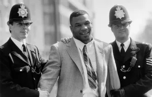 Mike Tyson being held by police March 1987 Mike Tyson being held by police March 1987