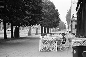 One mile from the Berlin Wall, on the East side, one lone person sitting having a drink