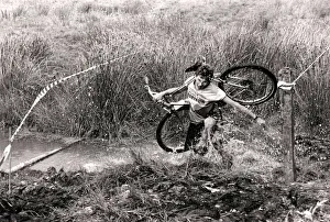 Mind how you go... a competitor carries his cycle across one of the many bogs negotiated Mind how you go... a competitor carries his cycle across one of the many bogs negotiated
