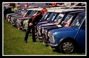 Images Dated 24th August 1999: Mini car August 1999 Woman looking at blue Minis Mini cars are at Silverston for 40th