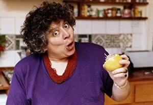 Miriam Margolyes actress eating an orange and pulling a face