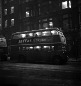 Prints of Fog scenes in the Strand. A London Transport bus seen here carrying commuters home through the winter gloom January 1951 B32-001 Weather Prints: Foggy Evening Print of a London Transport Bus in the Strand