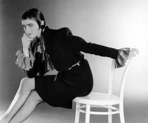Fashionable Women Of The 80s Prints: Fashion - Suits: Short black skirt with matching bolero-style jacket