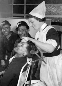 00026 Prints: Print of a nurse attending to a miner in a pithead surgery, January 1948