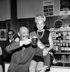 00033 Prints: Black and white print of a woman serving beer