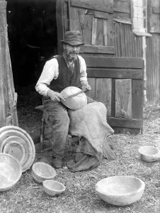 00038 Prints: George Lailey turning elm logs on a primitive foot lathe Print