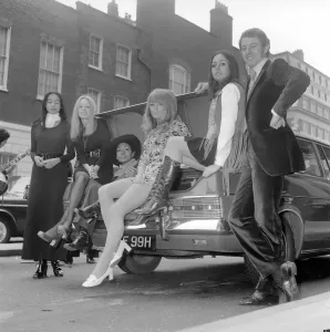 00039 Prints: A 1970 Pirelli calendar print features a racing driver with five models