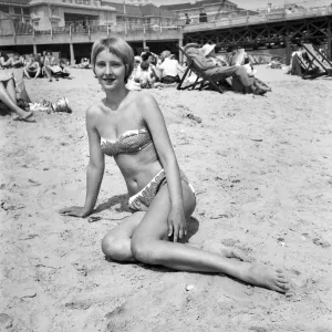 00039 Prints: Woman relaxing on the beach at Bournemouth Print