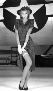 00040 Prints: A woman wears a print dress, paired with a hat, gloves and stockings