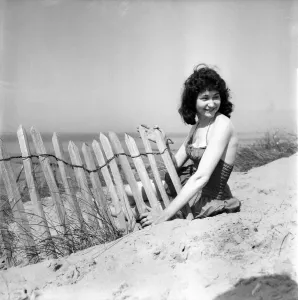 Woman In Swimsuit Prints: Glamour Girl. Barbara Stockton, 19 seen here posing on the beach. June 1960 M4295-001