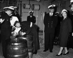 00041 Prints: The Queen watches Officer B.R.J. Hailstone issuing rum ration print April 1959