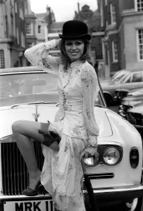 Prints of Joanna Lumley stars as Purdy in New Avengers 1976 poses in front of Silver shadow Rolls Royce motor car wearing bowler hat Actors And Actress Prints: Joanna Lumley as Purdy in Silver Shadow Rolls Royce Print