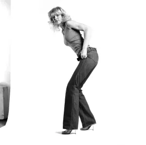 80s Fashion Prints: Fashion: Clothing: A woman pulling up a pair of denim jeans. January 1981 81-00051-006