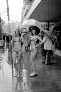 Vintage Bikini Styles Prints: Models Wendy and Jackie seen here modeling the latest in swimwear on a wet Oxford Street