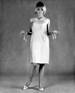 60s Fashion Trends Prints: Mannequin seen here modeling a summer dress with a pull draw belt. August 1965 P007742