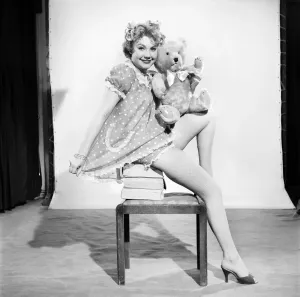 Vintage Fashion Photography Prints: Model Audrey Nicholson wearing nightee seen here with her Teddy bear. 1959