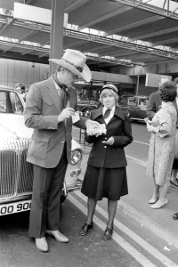 00063 Prints: Larry Hagman Arrives at Heathrow Airport Print, June 1980