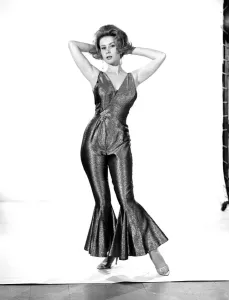 60s Fashion Trends Prints: Model Rita Royce wearing lurex suit. Circa 1963