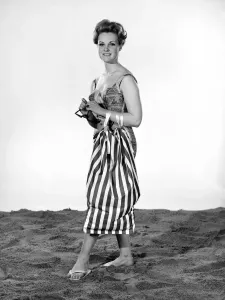 Retro Swimwear Designs Prints: Model Roma Reeves wearing beach toga that doubles as a beach towel. May 1962