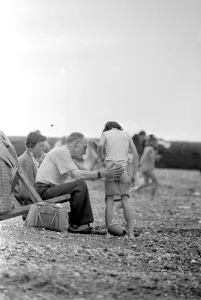 00087 Prints: Family Help Young Boy Change on Brighton Beach Print 1958