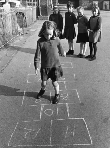 Young Girl Playing Hopscotch in School Playground Print 1967