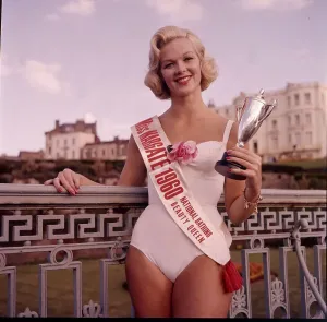 Retro Swimwear Fashion Prints: Winner of the Miss Margate beauty pageant posing with trophy at the Winter