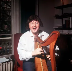 Benny Hill in Kensington Flat Playing Harp Print 1966