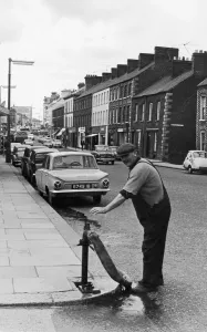 Prints of A workman from the local water board seen here working a standpipe in Portadown. Circa 1966 County Armagh Prints: Water Board Workman at Portadown Standpipe Print, Circa 1966