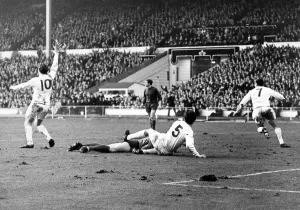 Prints of 1967 League Cup Final at Wembley Stadium. Queens Park Rangers 3 v West Bromwich Albion 2. Sheppard and Hunt of West Brom lay on the ground as QPRs Mark Lazarus (7) scores. 4th March 1967 Sport Prints: 1967 League Cup Final Print: QPR 3 v West Brom 2 at Wembley