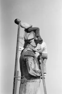 Prints of Catching the sun on the highest spot in London. The statue of Nelson at the top of the column is being cleaned once again, and steeplejacks perched on the top made the most of the sun Weather Prints: Catching the Sun on Nelson's Column, London Print 1980