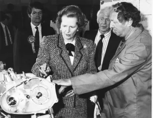 Prints of Baronnes Margaret Thatcher accompanied by Patrick Nicholls (left) during a visit to the L F Harris factory Triumph motorcycles Newton Abbot 27th May 1987 Politic Prints: Baroness Thatcher with Patrick Nicholls, 27th May 1987 Print
