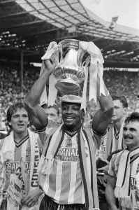 Cyrille Regis Prints: Cyrille Regis Holds the FA Cup, 1987 Print