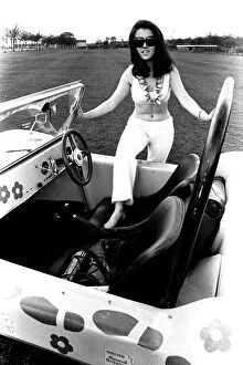 A model in a beach buggy wearing a blouse and trousers in April 1970