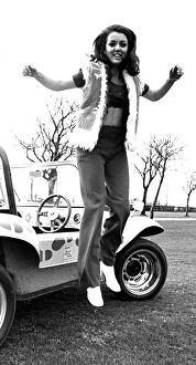 A model in a beach buggy wearing trousers and a fur gillet in April 1970