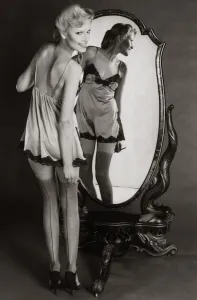 A model dressing up in 1940s style night dress with painted on seamed stockings A model dressing up in 1940s style night dress with painted on seamed stockings