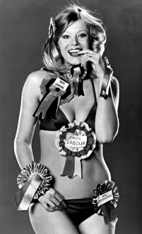 Model Jan Burdette wearing a collection of rosettes on the day of the General Election Model Jan Burdette wearing a collection of rosettes on the day of the General Election