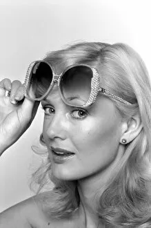Model Maria wearing a pair of sunglasses. June 1980 80-03010-003