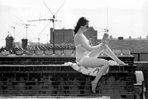 00060 Gallery: A model wearing a bikini reading a book as she sunbathes on a rooftop on Kings Road in