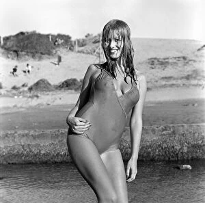 Model wearing a one piece swimsuit as she poses on a beach in Africa April 1975
