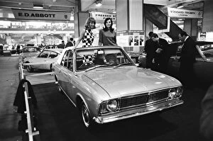 Images Dated 22nd October 2010: Models posing in this soft top Ford Cortina Mark 2 at the London Motor Show 18th October